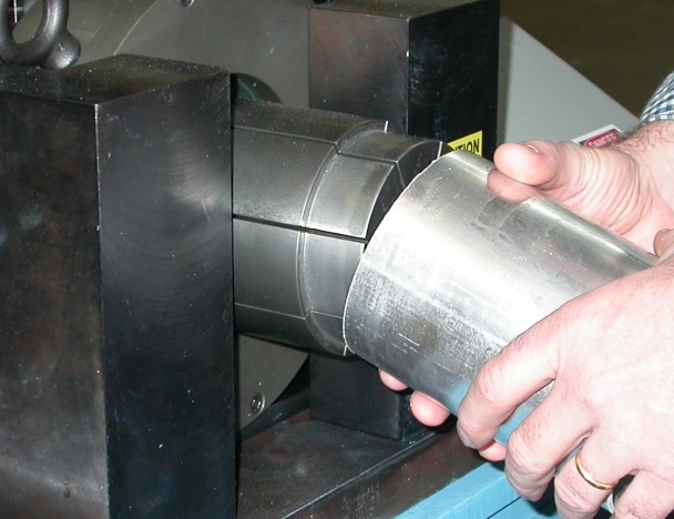 A segmented die set consisting of a set of segmented fingers and a tapered spear - Winton Machine USA