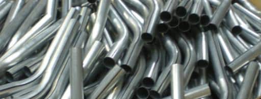 Large pile of bent tubes after production - Winton Machine USA